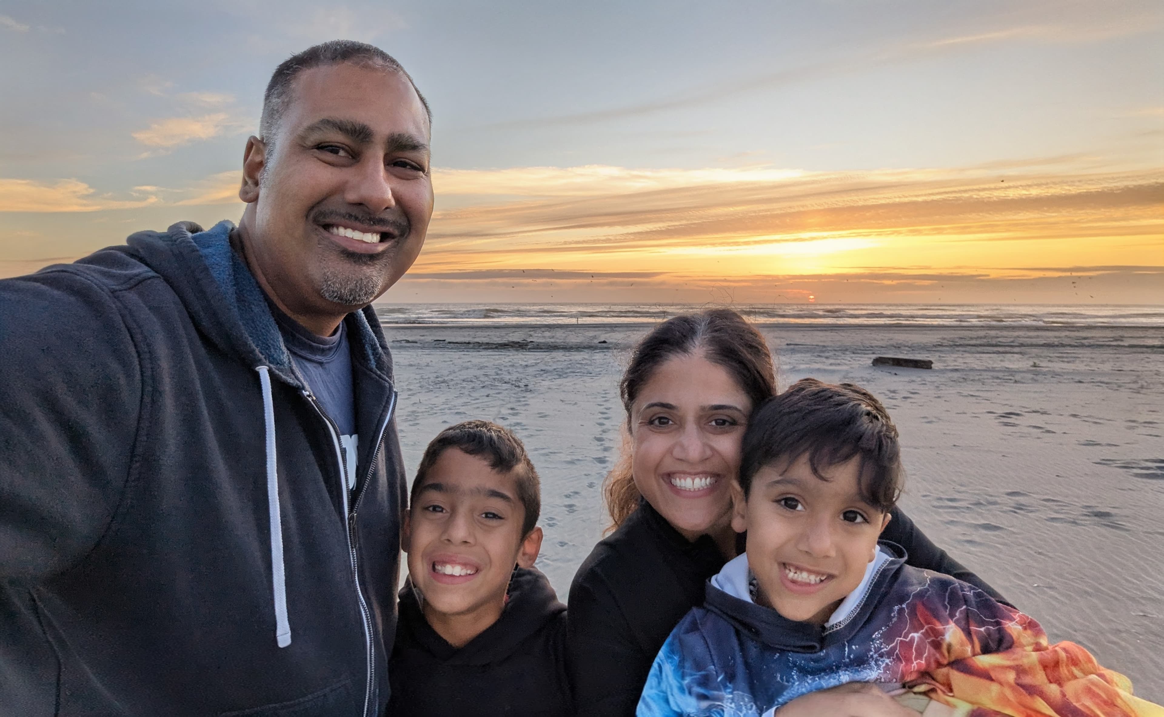 Karim Merchant with his family on the Washington coast